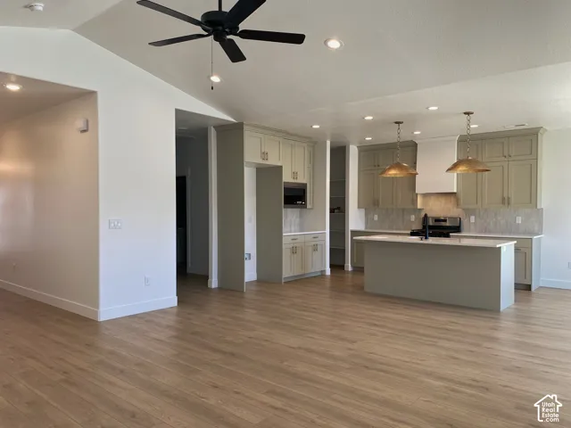 *COMPARABLE HOME, EXAMPLE OF LISTING AFTER COMPLETION.Vaulted ceiling with a black ceiling fan, recessed lighting, and wood-finish flooring