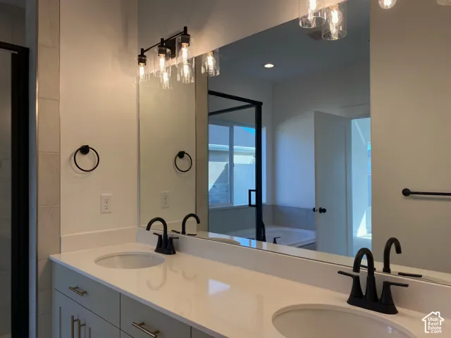 *COMPARABLE HOME, EXAMPLE OF LISTING AFTER COMPLETION. Dual-sink vanity with matte black fixtures, light-toned countertop, and recessed lighting. LISTING DOES NOT INCLUDE TUB