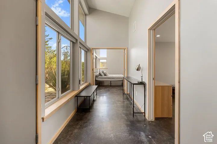 Vaulted ceiling, polished concrete flooring, extensive window array, natural wood trim, recessed lighting