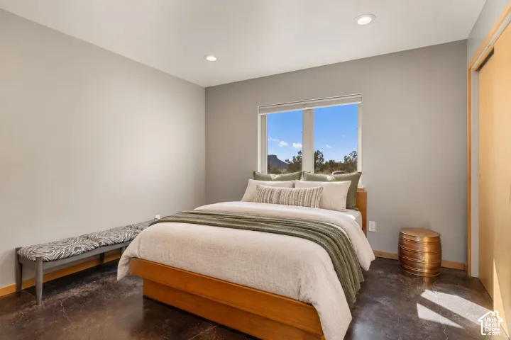 Recessed lighting, wood-finish flooring, and a large window