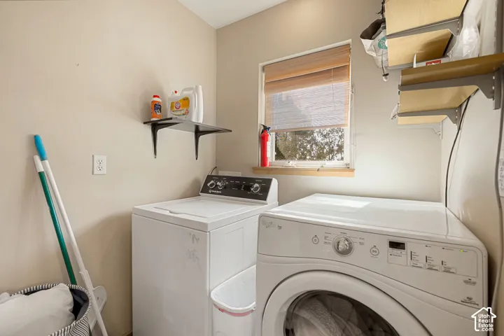 Laundry area featuring a window, built-in shelving, and light-colored walls
