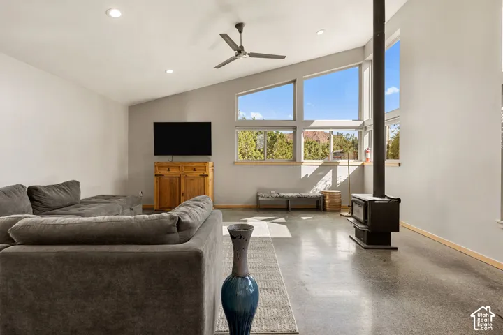Vaulted ceiling with recessed lighting and a ceiling fan