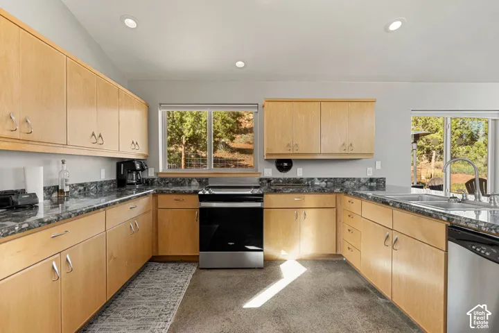 U-shaped kitchen featuring light wood cabinetry, stone countertops, a stainless steel dishwasher, an electric range, and recessed lighting