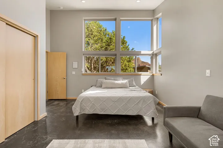 Polished concrete flooring, recessed lighting, and expansive windows