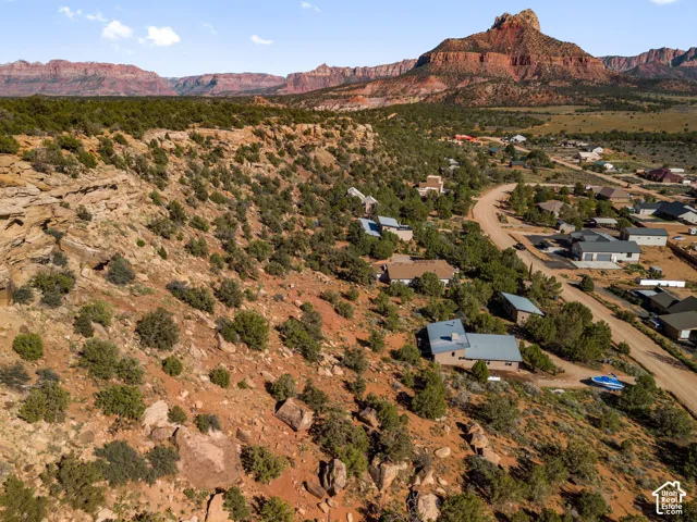 Expansive desert landscape featuring natural rock formations and abundant native vegetation