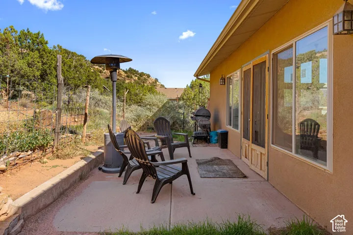 Concrete patio with stucco exterior and large windows