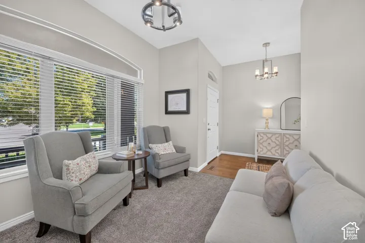 Arched window, high ceilings, recessed lighting, wood-finish flooring, and a decorative console