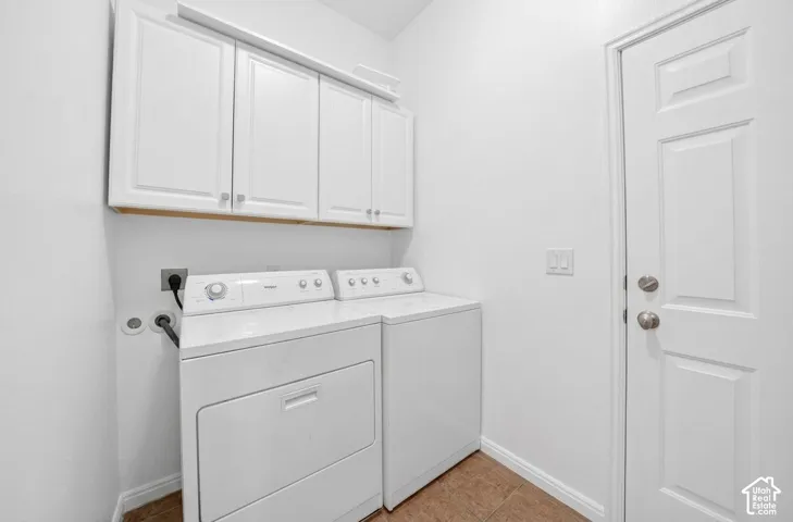 White shaker-style cabinetry with gold-toned pulls