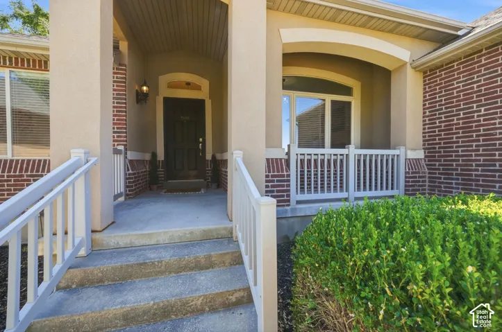 Brick exterior with stucco accents, covered entry, and a prominent front door with arched transom