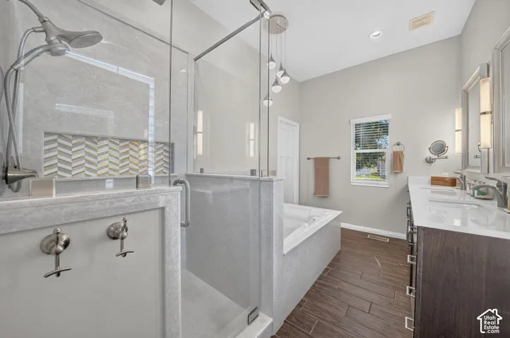 Glass-enclosed shower with a chevron-patterned tile niche