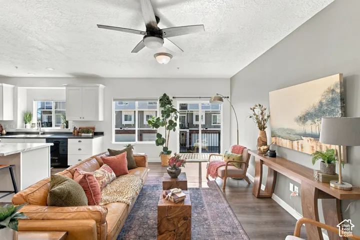 Open-concept living space featuring wood-finish flooring and a ceiling fan