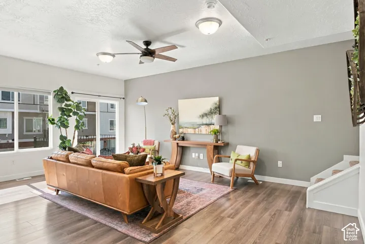 Recessed lighting, wood-finish flooring, ceiling fan with integrated lighting, sliding glass door, and large windows