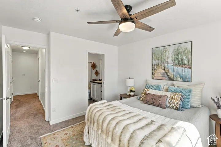 Recessed lighting, wood-finish ceiling fan with integrated light, white walls, and plush carpet flooring