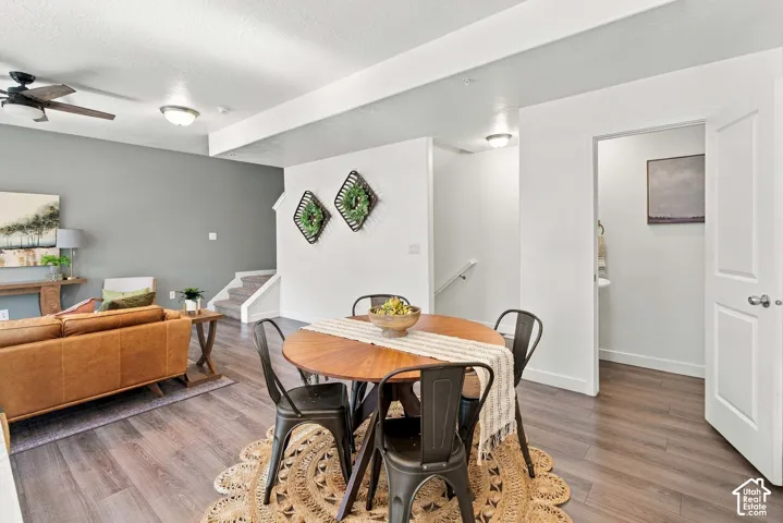 Open-concept living space with wood-finish flooring, recessed lighting, and a ceiling fan