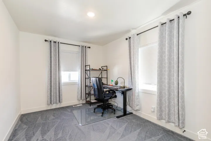 Recessed ceiling lighting, two windows, wall-to-wall carpeting, and white trim