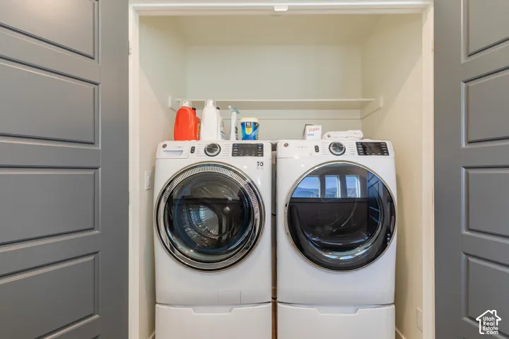 Built-in laundry closet with two panel doors and an integrated shelf