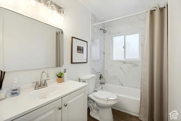 White vanity with a single basin sink and brushed nickel faucet
