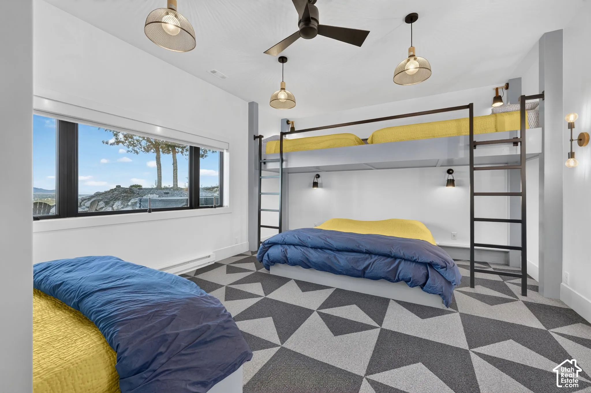 Geometric pattern flooring, built-in bunk beds with ladders, multiple lighting fixtures, ceiling fan, and expansive horizontal window