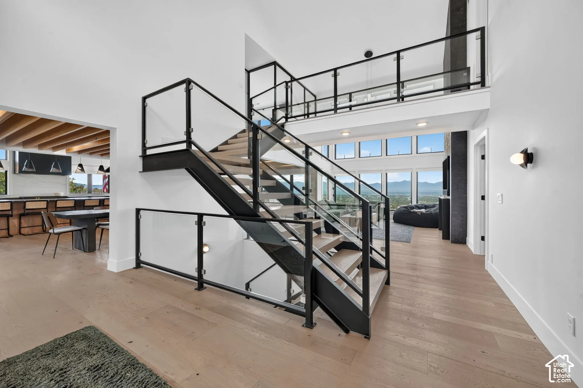 Contemporary open-tread staircase with glass and black metal railings