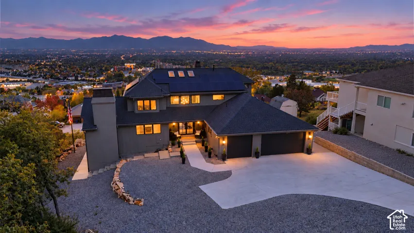 Expansive gravel driveway leading to a two-car garage
