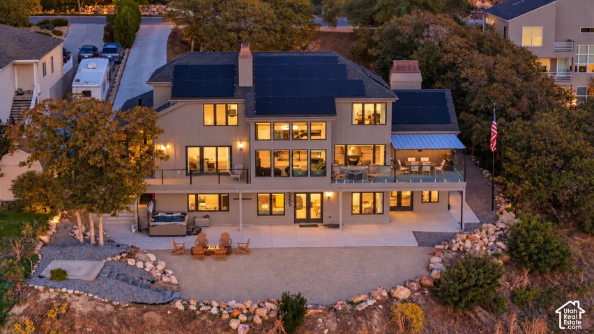 Multi-level exterior with extensive decking, a ground-level patio, and a dedicated spa area