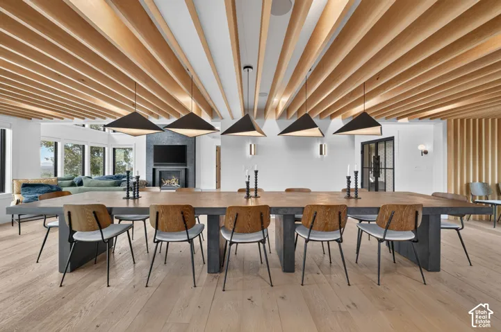 Open-concept living area with wood-finish flooring, a wood-slat ceiling design, and recessed lighting