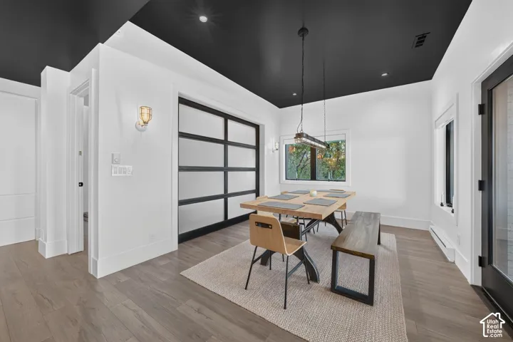 Wood-finish flooring throughout, complemented by a contrasting black ceiling