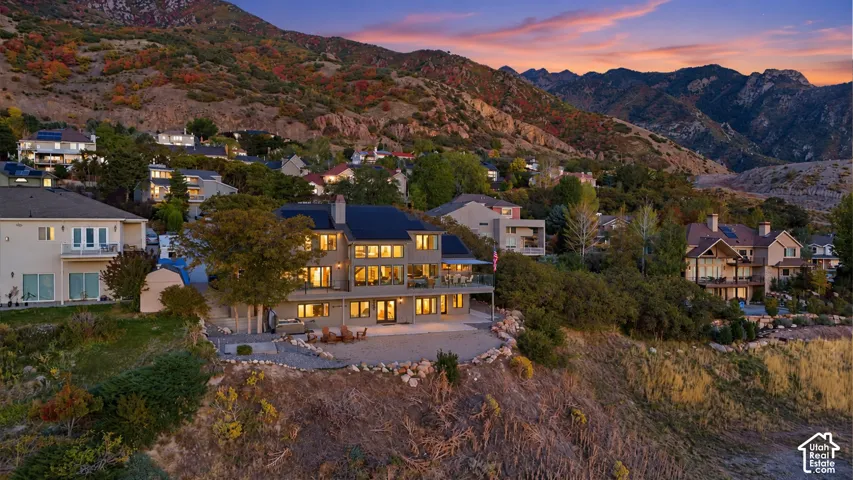 Hillside residence featuring multiple levels, extensive windows, and a multi-level deck