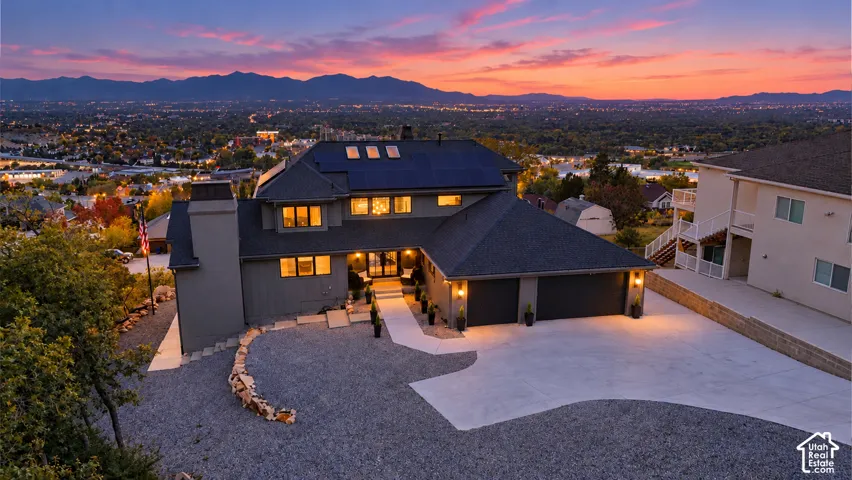 Expansive gravel driveway leading to a two-car garage