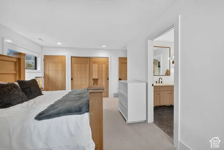 Recessed lighting, wood-finish doors, and broad windows with trim