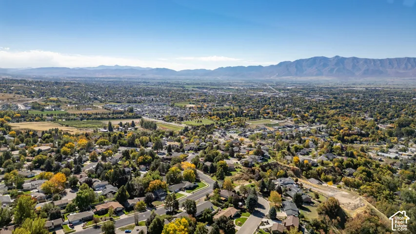 Expansive community setting with varied housing, mature landscaping, and mountain backdrop