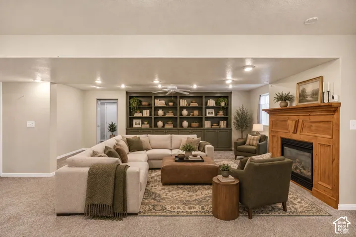 Recessed lighting, wood-finish fireplace mantel, built-in shelving, ceiling fan