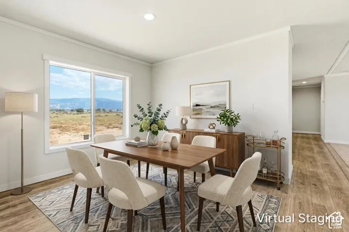 Recessed ceiling lighting, wood-finish flooring, and white trim