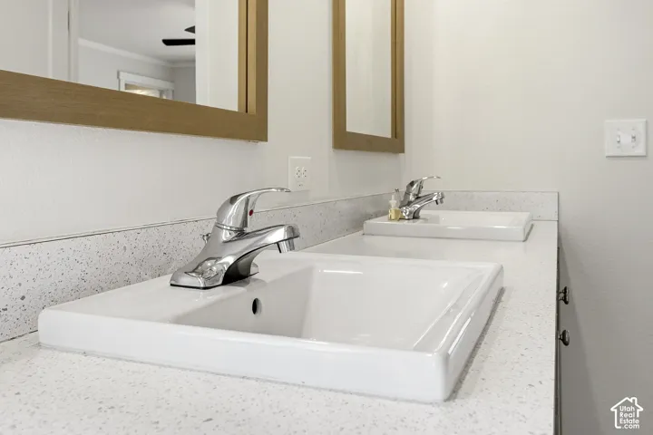 Dual rectangular undermount sinks, chrome fixtures, and speckled countertops