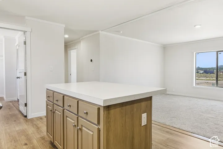 Kitchen island with light-toned cabinetry and a light countertop
