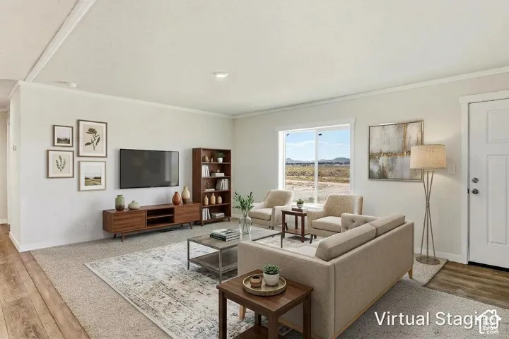 Spacious living area featuring light-colored walls, crown molding, and recessed lighting