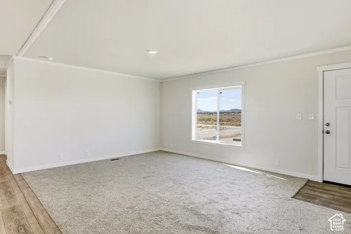 Bright interior space featuring light-colored walls, recessed ceiling lighting, and a white paneled door