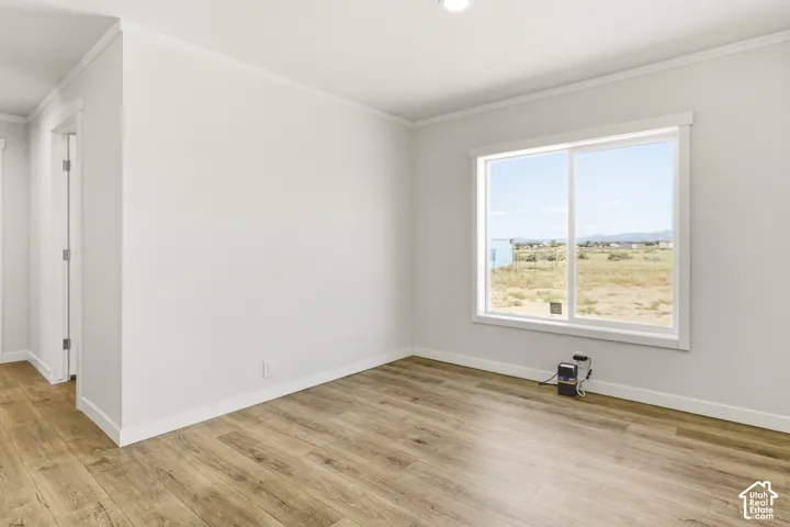 Room featuring wood-finish flooring, a large window, and recessed ceiling lighting