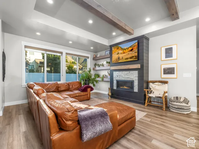 Living area with wood-finish flooring and recessed lighting