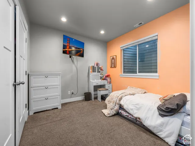Recessed ceiling lighting, wall-to-wall carpeting, and a white-framed window