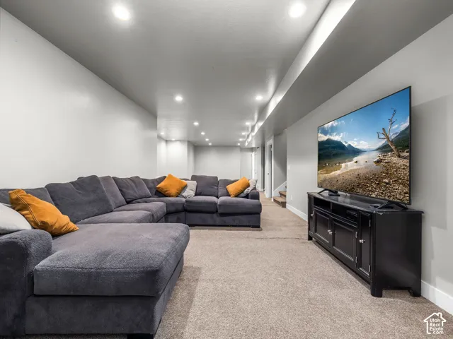 Recessed ceiling lighting, light gray wall paint, and gray carpet flooring