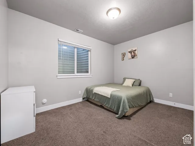 Neutral wall paint, plush carpet flooring, recessed window, and flush-mount ceiling light