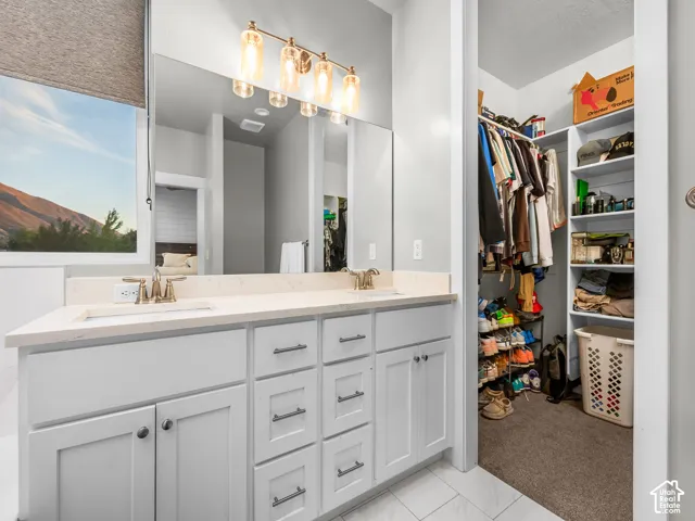 Double vanity with light-colored countertop and integrated sinks