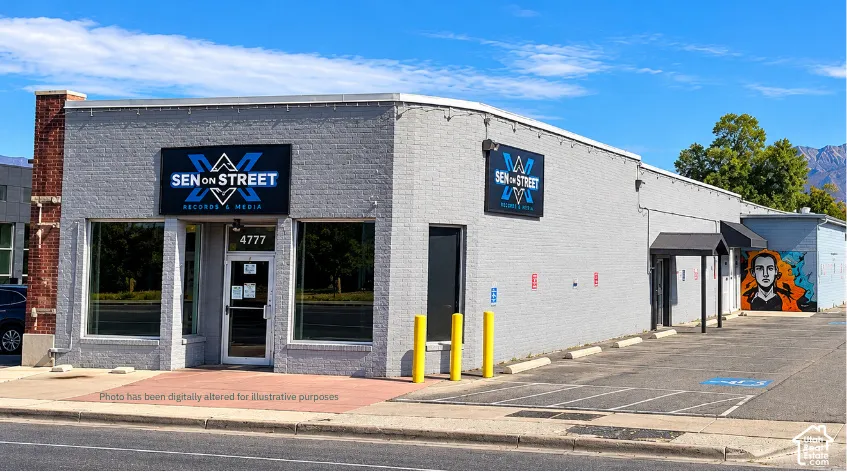 Commercial storefront with a painted brick facade, multiple display windows, and a glass entry door