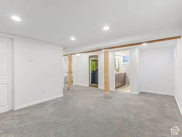 Bright and spacious basement family room with exposed wood beams