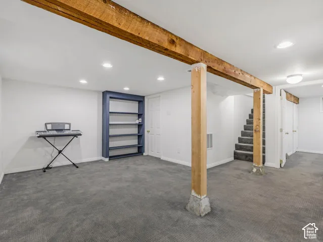 Bright and spacious basement family room with exposed wood beams