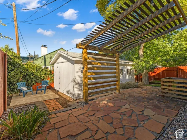 You will LOVE the beautiful, well-designed backyard! Two seating areas, flagstone patio with covered portico, and more! Fully fenced and private. Also, see the oversized 1-car garage.