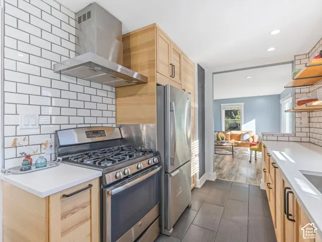 Stainless appliances and range hood in updated kitchen