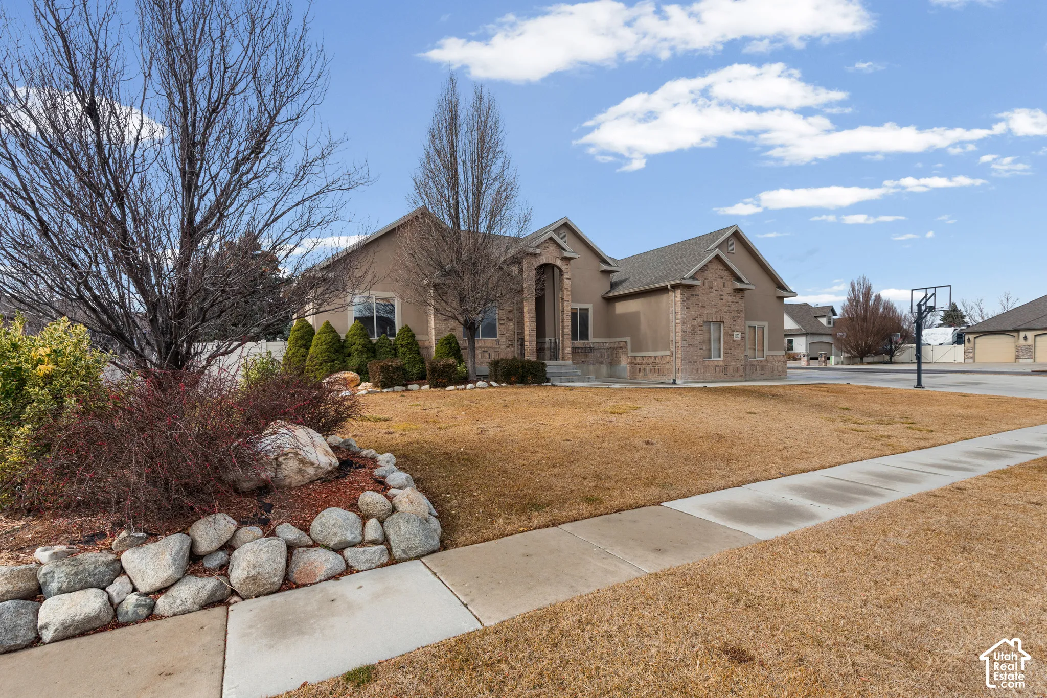 Single-story stucco and brick exterior with arched entry