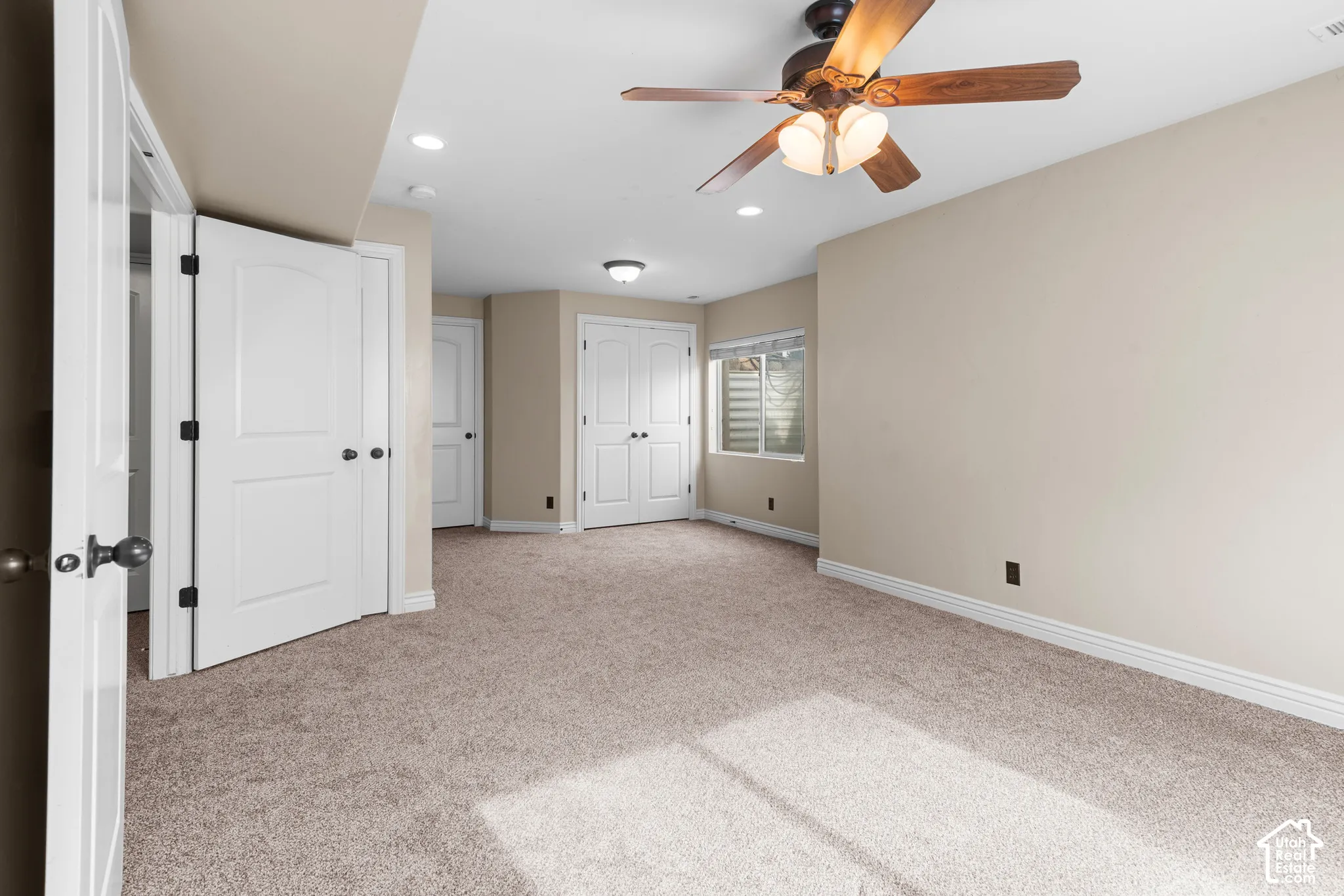 Neutral-toned carpeting, recessed lighting, ceiling fan with light fixture, and white trim